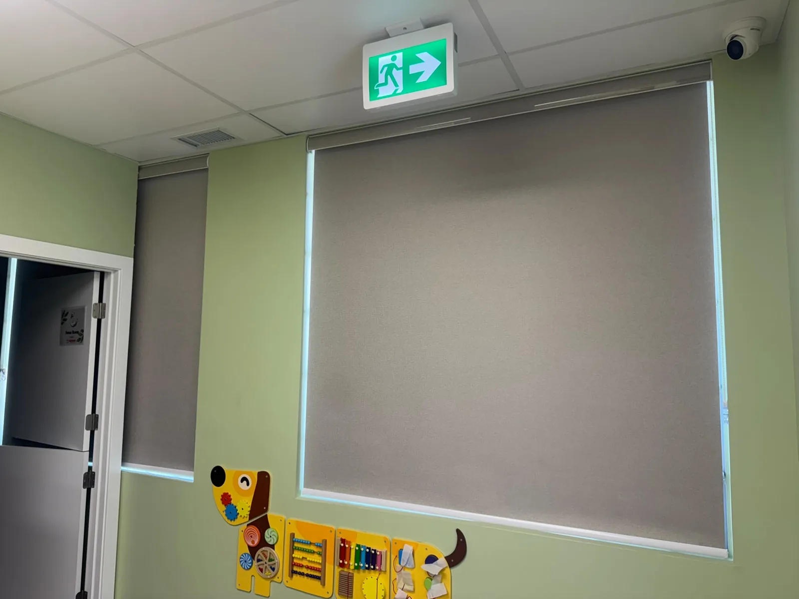 Light-filtering commercial roller blinds installed in an Edmonton daycare