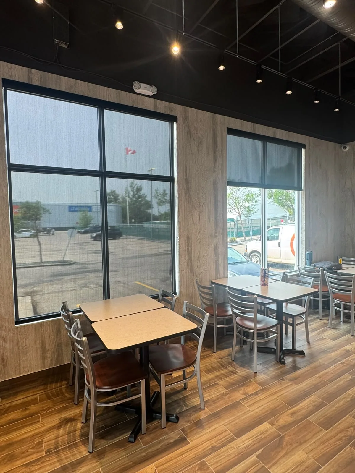 Sunscreen roller blinds installed around an Edmonton restaurant dining area