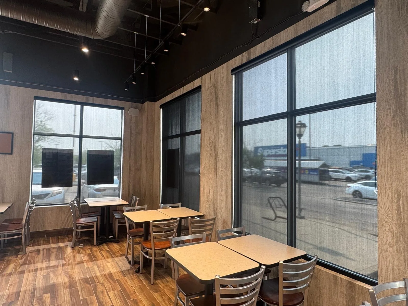 Sunscreen roller blinds reducing glare in an Edmonton restaurant